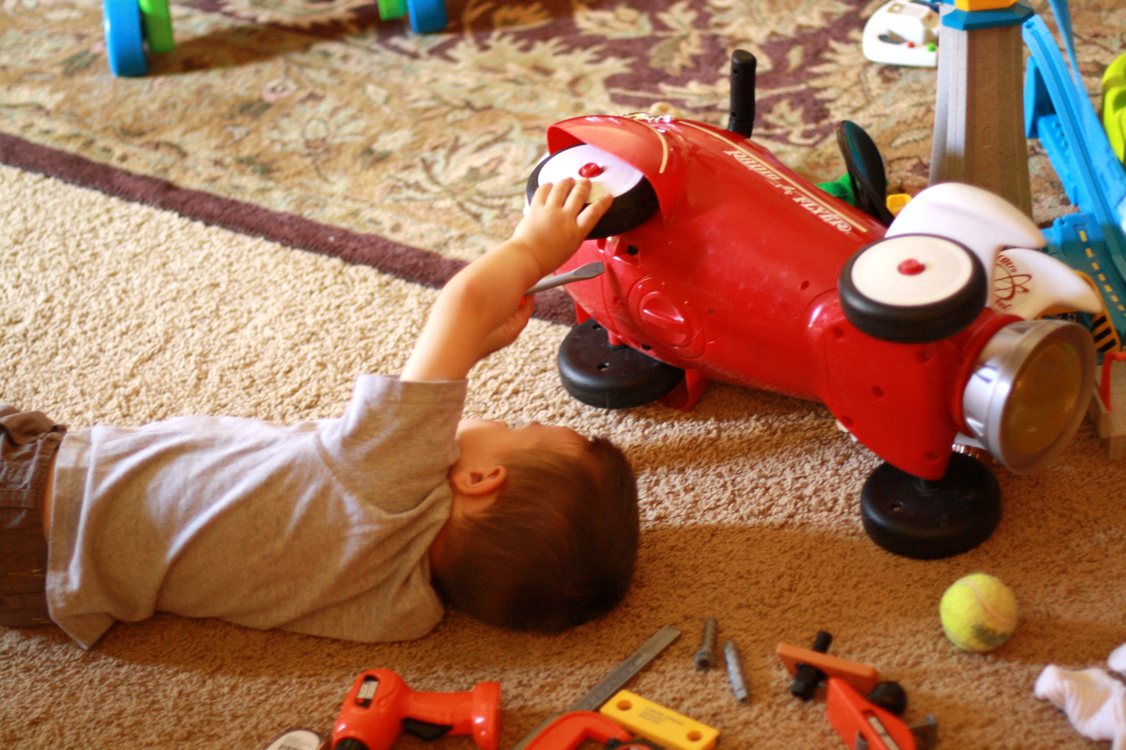 boy fixing a toy