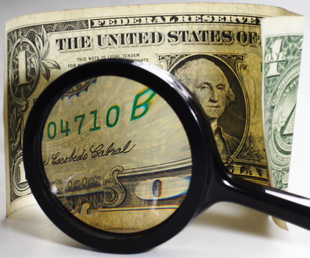 photograph of a dollar bill viewed under a magnifying glass